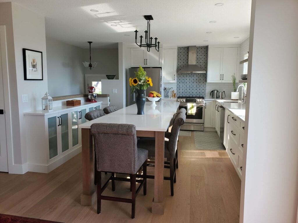 renovated kitchen with white cabinetry and stainless steel appliances